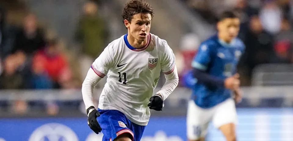 Player in white jersey sprinting during soccer match
