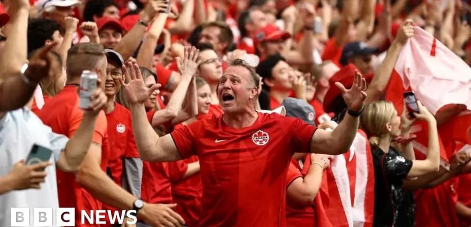 Crowd of Canadian fans celebrating at a match