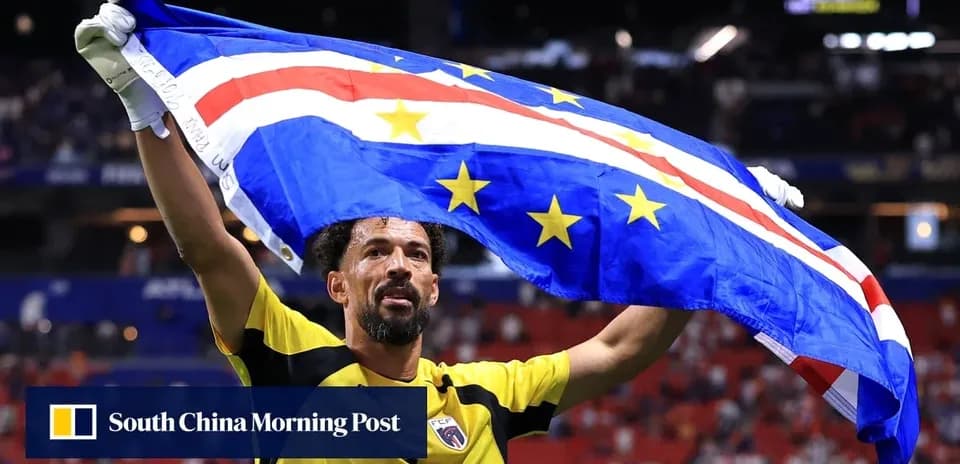 Player celebrating with Cape Verde flag after match