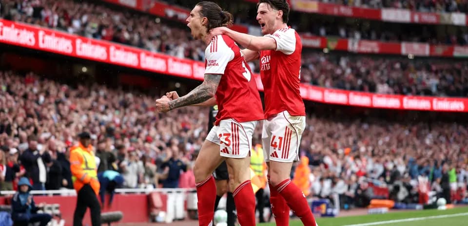 Arsenal players celebrating a goal at Emirates Stadium