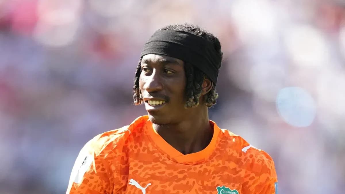 Goalkeeper wearing orange jersey during warm-up