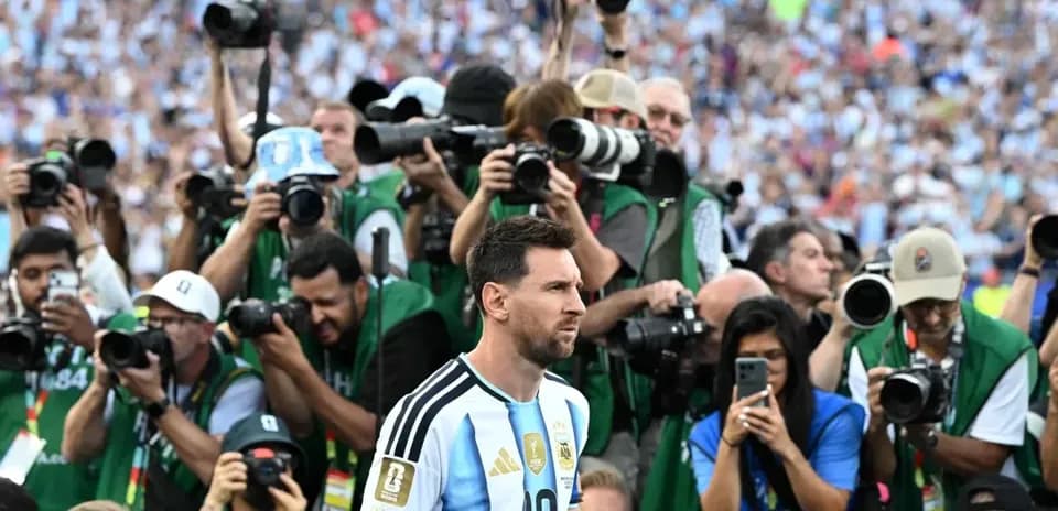 Lionel Messi surrounded by photographers at match