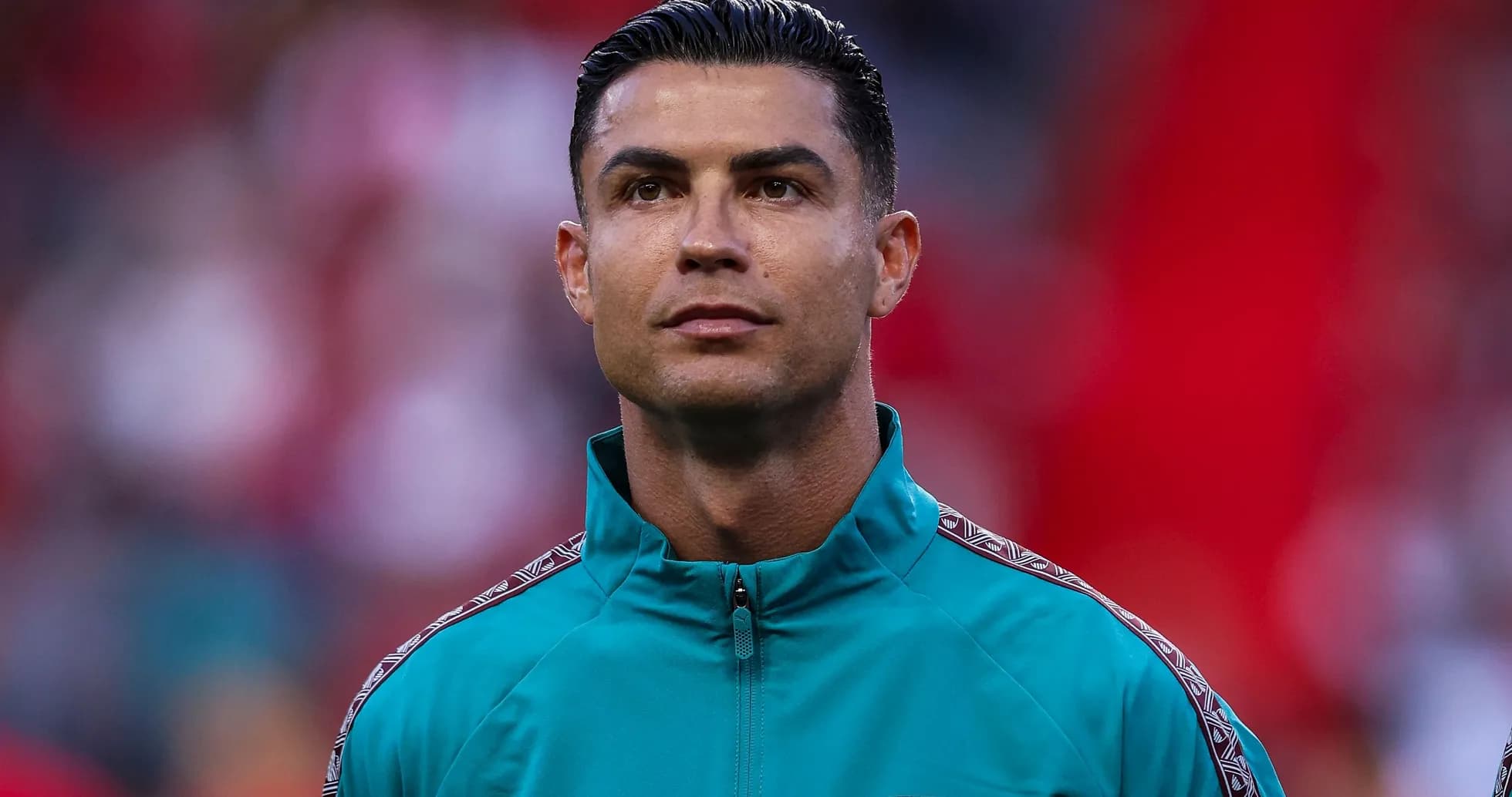Player in teal jacket during pre-match ceremony