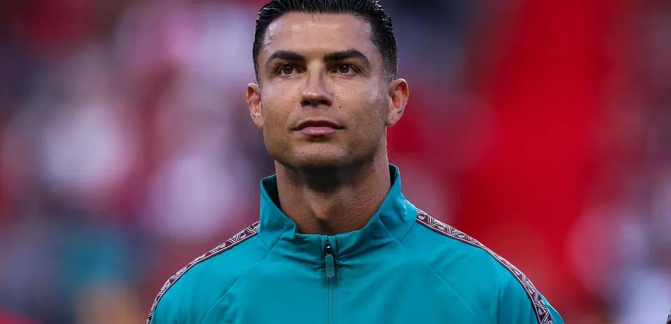 Player in teal jacket during pre-match ceremony