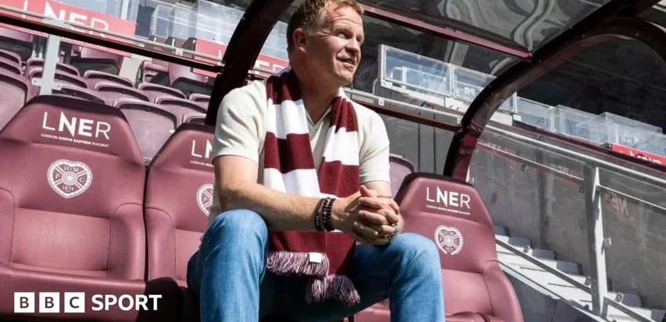 Manager seated in dugout at stadium
