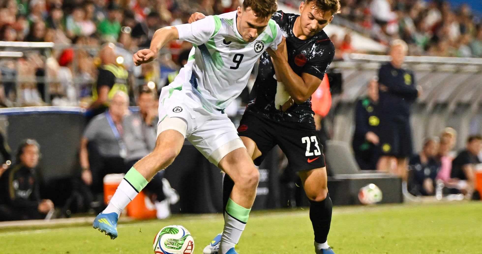 Two players competing for the ball during soccer match