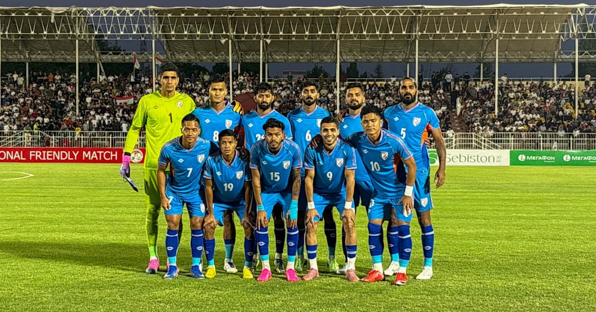 Football team posing for photo before friendly match