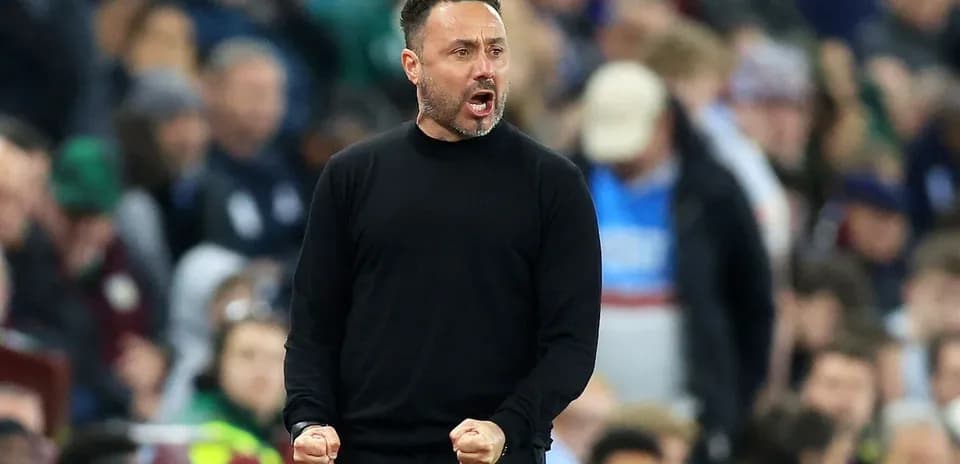Manager celebrating passionately on the sidelines