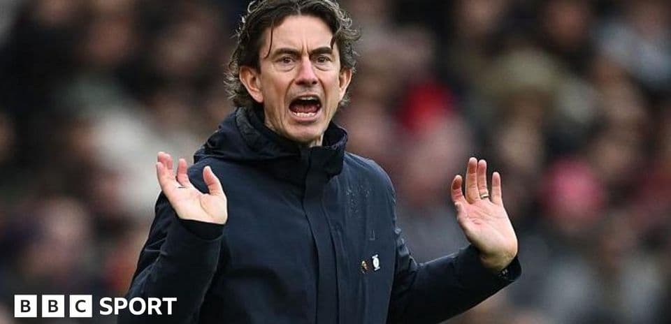 Manager gesturing during a match from the sidelines