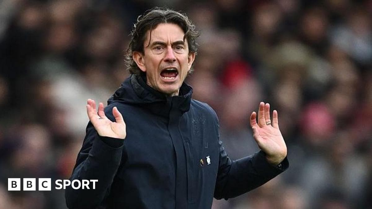 Manager gesturing during a match from the sidelines