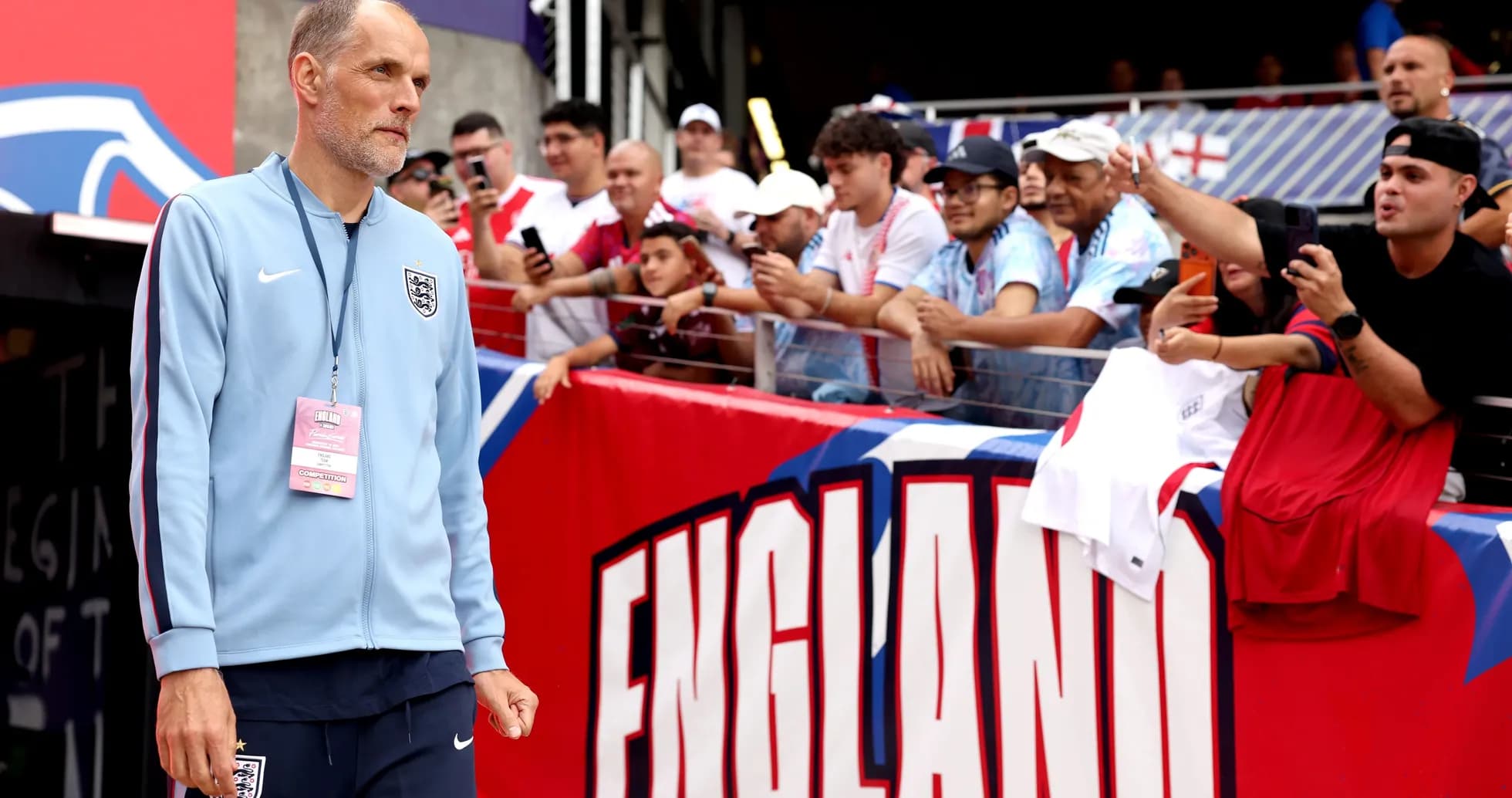Coach walking towards fans before the match