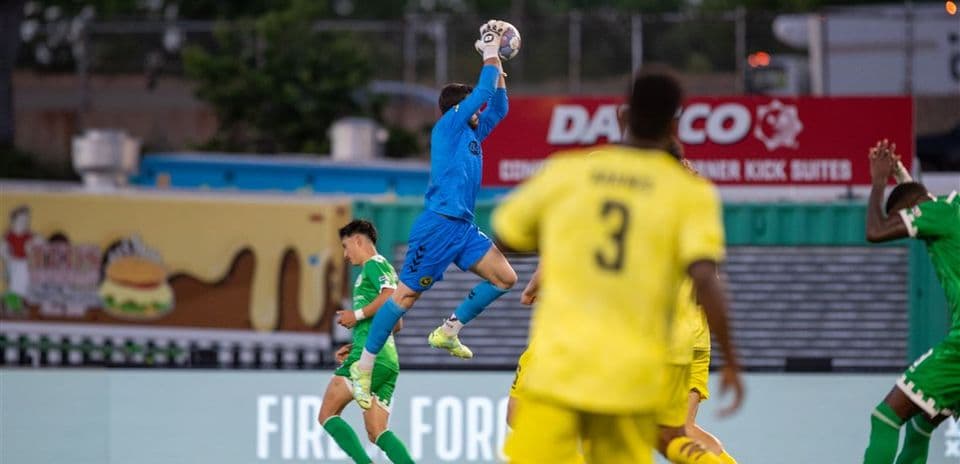Goalkeeper catching the ball during match