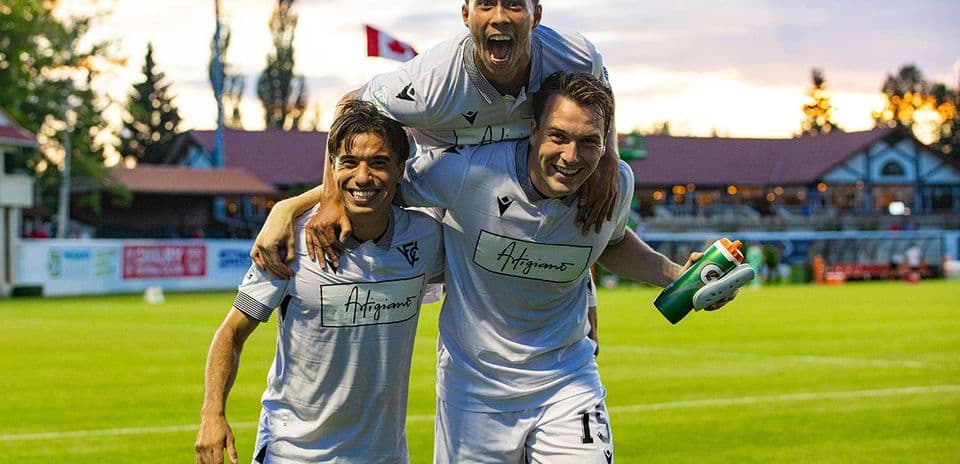 Vancouver FC players celebrating on the field