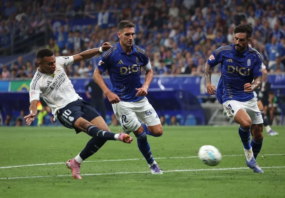 Real Madrid player taking a shot on goal