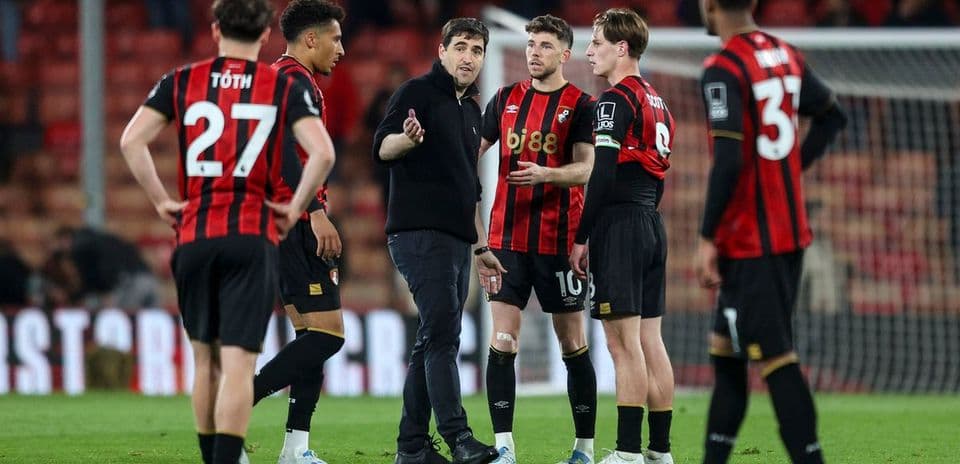 Bournemouth players discussing with their coach during match