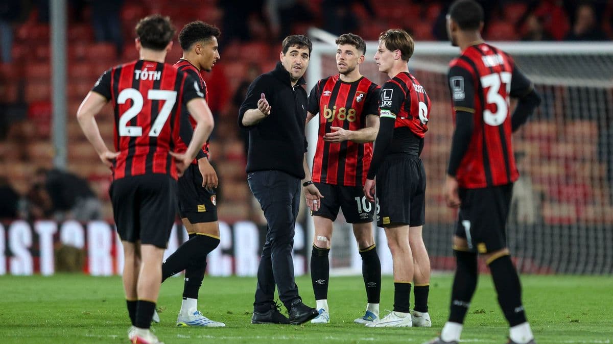 Bournemouth players discussing with their coach during match