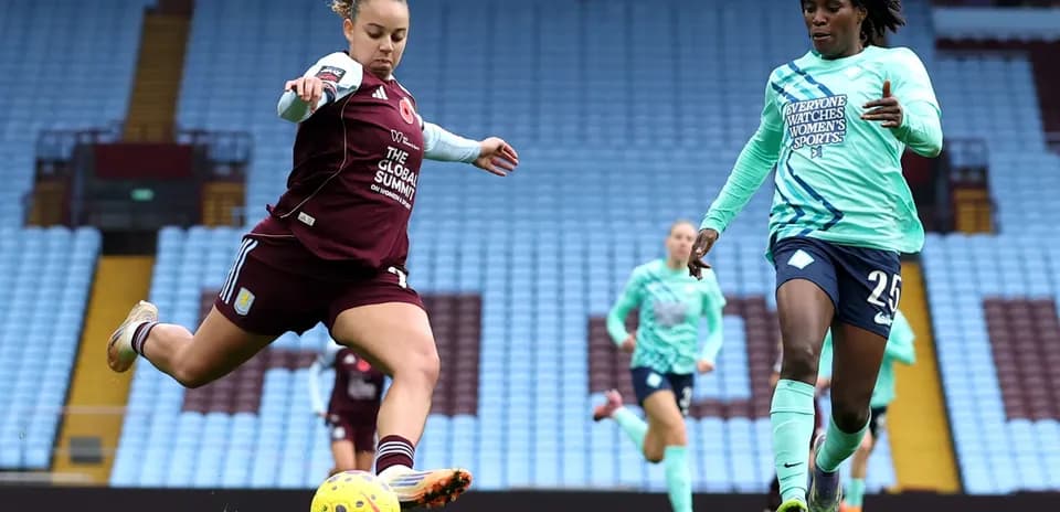 Aston Villa player kicking the ball in match