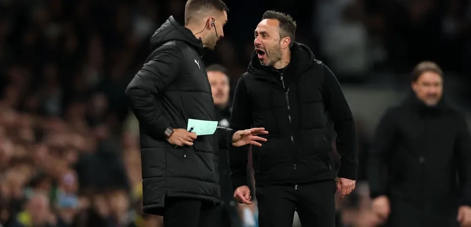Two coaches discussing strategies during a match
