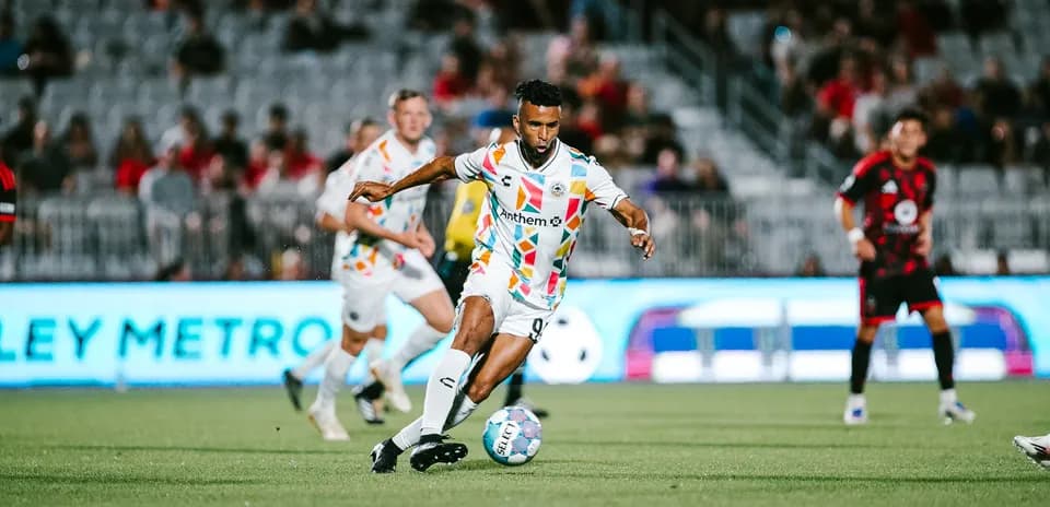 Player dribbling the ball during USL Championship match