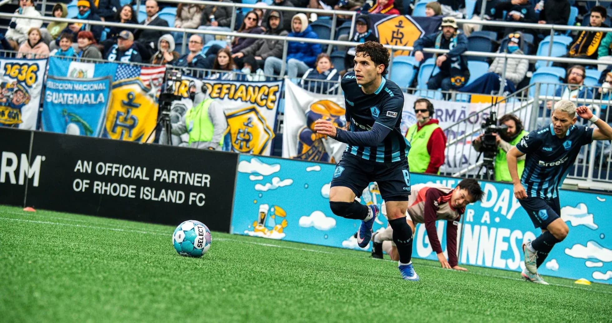 Player advancing with ball during Rhode Island match Player advancing with ball during Rhode Island match