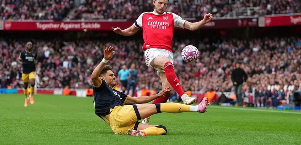 Player tackling during West Ham vs Arsenal match Player tackling during West Ham vs Arsenal match