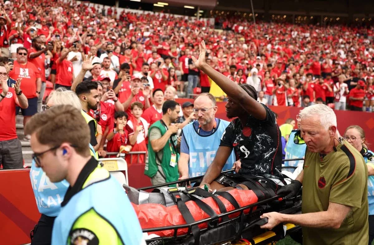 Player on stretcher leaving field amid cheering crowd Player on stretcher leaving field amid cheering crowd