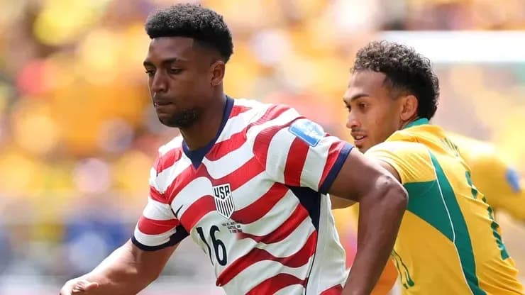 Player in striped USA jersey running with ball Player in striped USA jersey running with ball