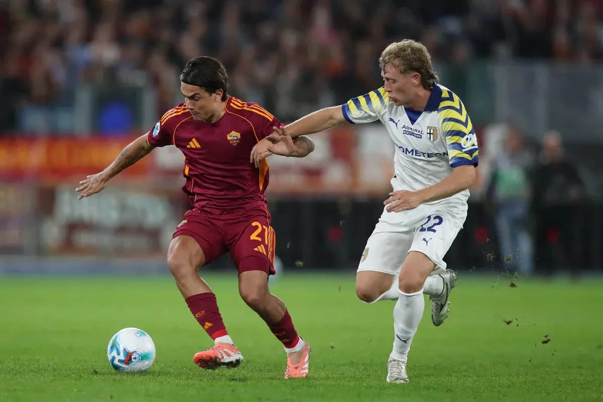 AS Roma player dribbling past Parma defender AS Roma player dribbling past Parma defender