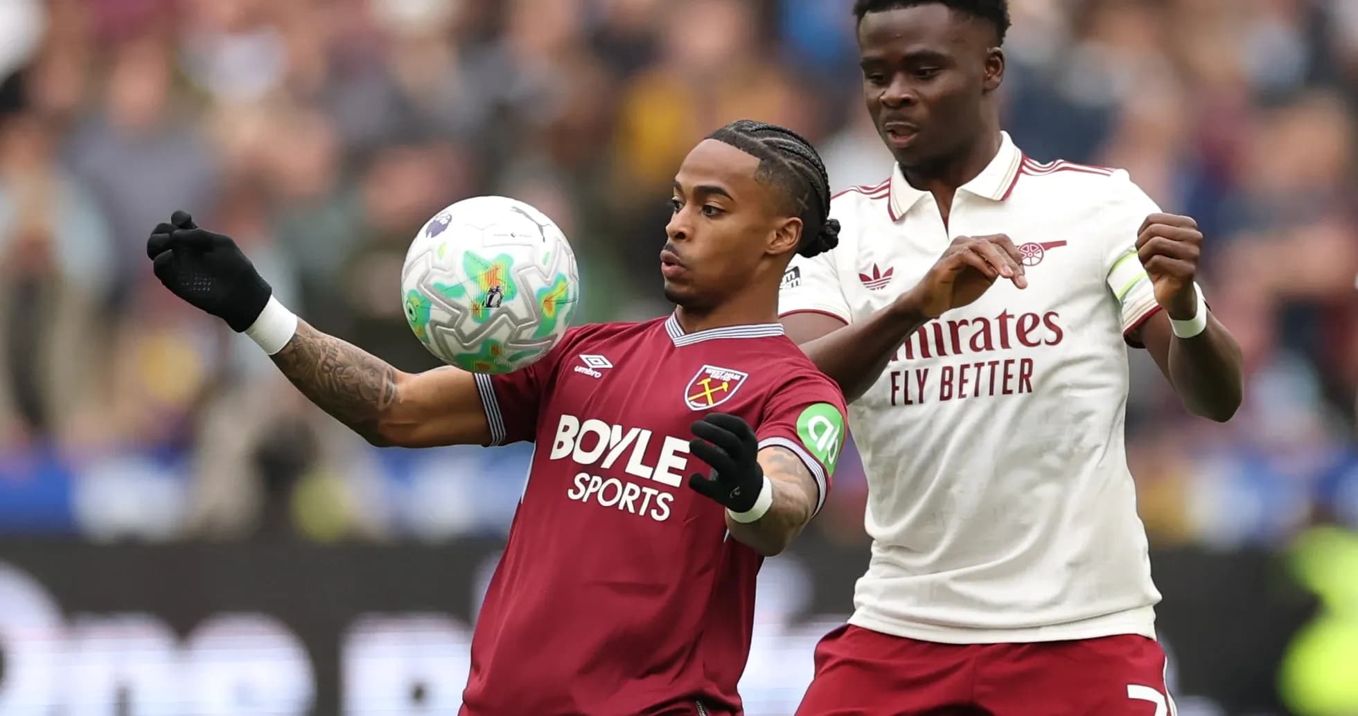 West Ham player controlling the ball against Arsenal West Ham player controlling the ball against Arsenal