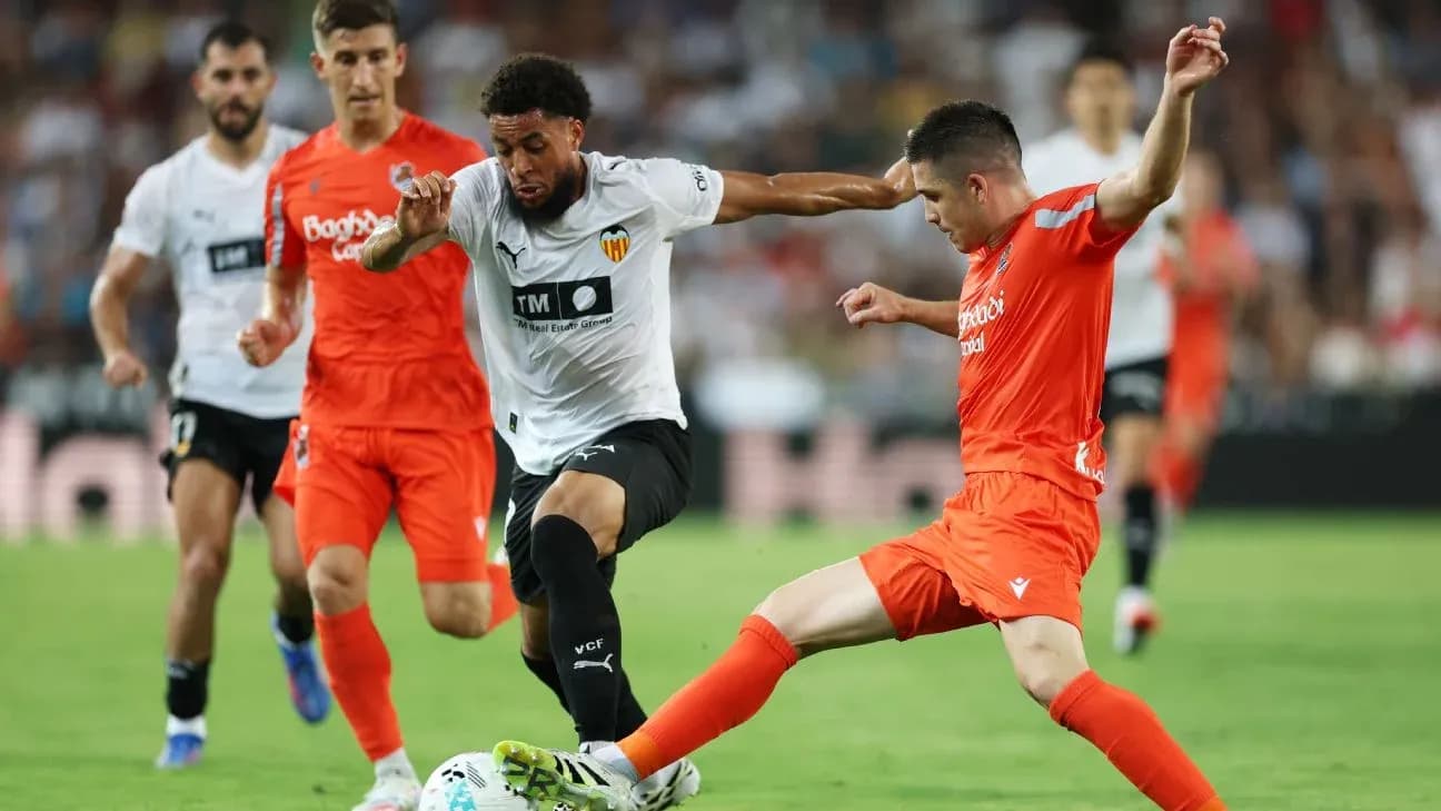 Real Sociedad player tackling Valencia opponent Real Sociedad player tackling Valencia opponent