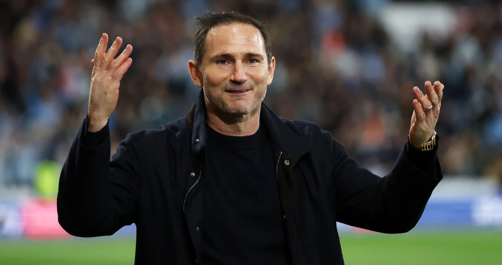 Coach gesturing towards fans during match celebration Coach gesturing towards fans during match celebration