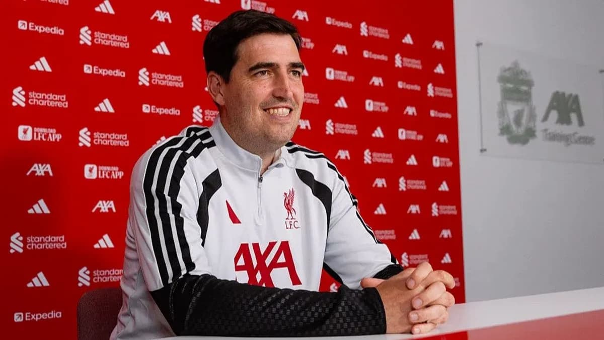 Coach sitting at press conference table at training center Coach sitting at press conference table at training center