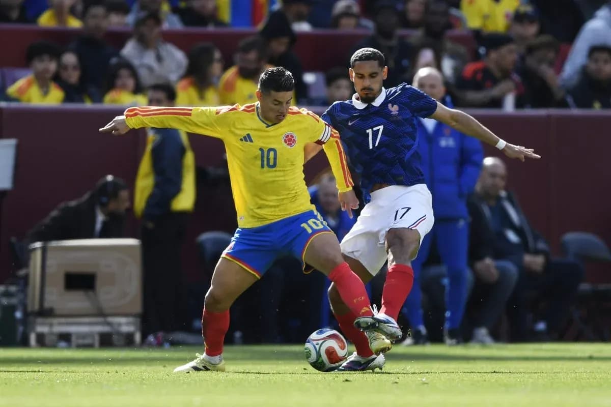 Colombian player challenges French player for the ball Colombian player challenges French player for the ball