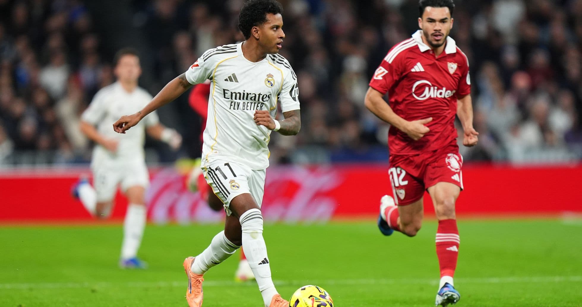 Real Madrid player dribbling against Sevilla Real Madrid player dribbling against Sevilla
