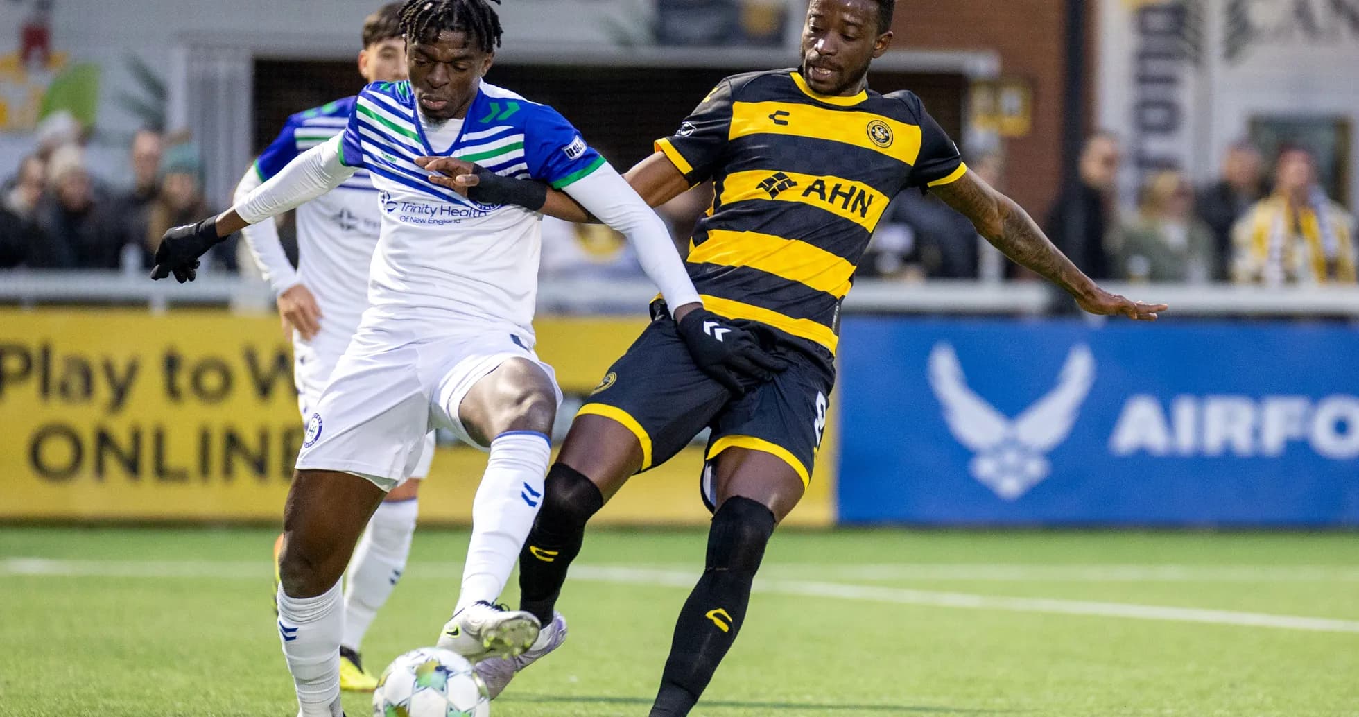 Players competing for the ball in USL Championship Players competing for the ball in USL Championship