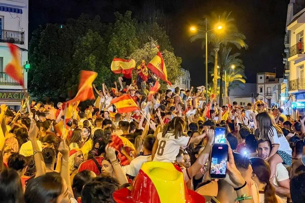 Crowd celebrating with flags at night Crowd celebrating with flags at night