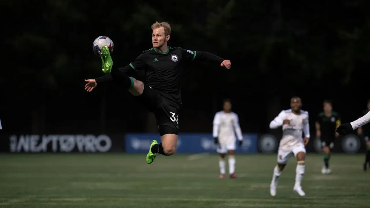 Player kicking ball during Tacoma Defiance match Player kicking ball during Tacoma Defiance match