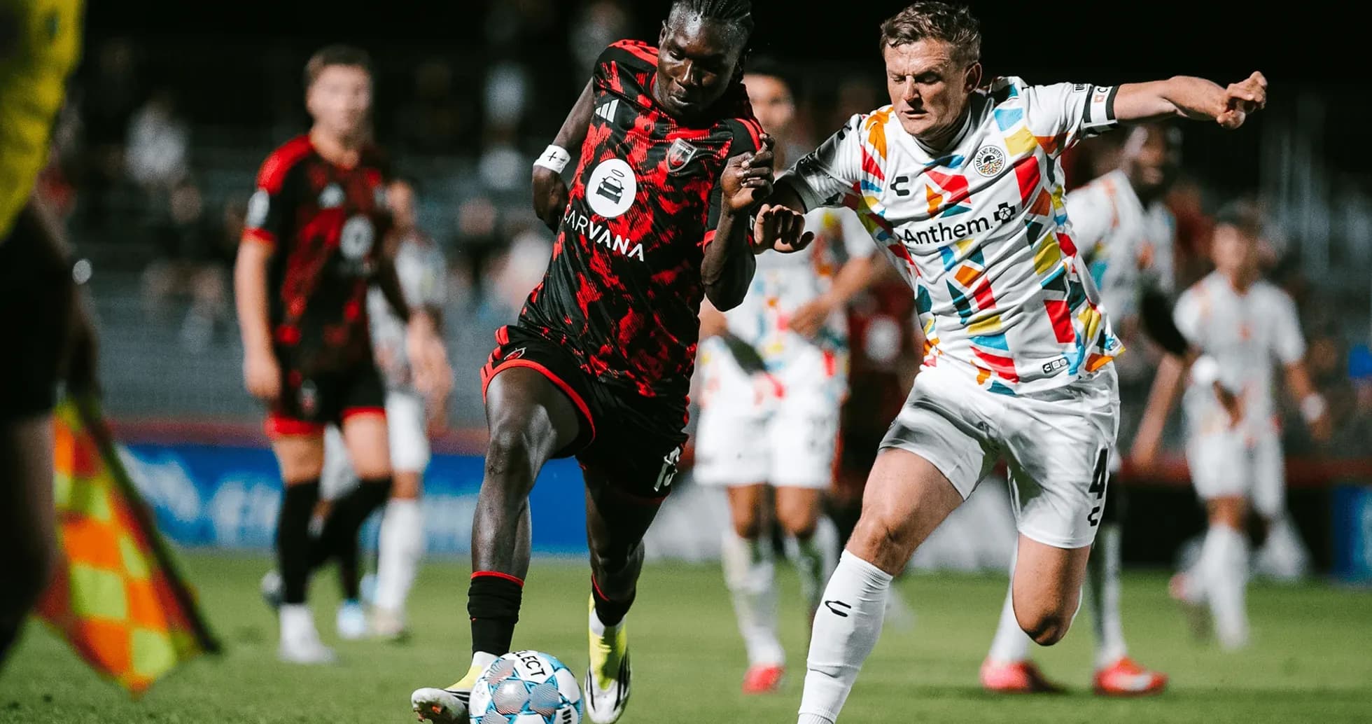 Two players competing for the ball in match Two players competing for the ball in match