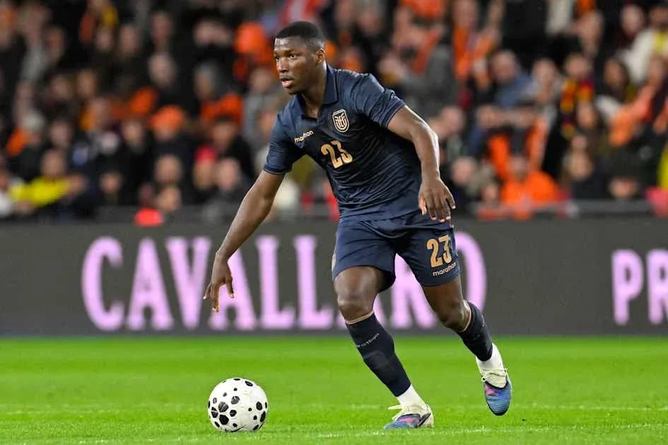 Player in dark uniform dribbling ball during match Player in dark uniform dribbling ball during match