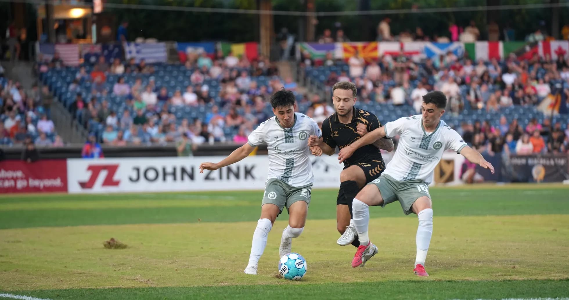 Players competing for the ball in USL Championship Players competing for the ball in USL Championship