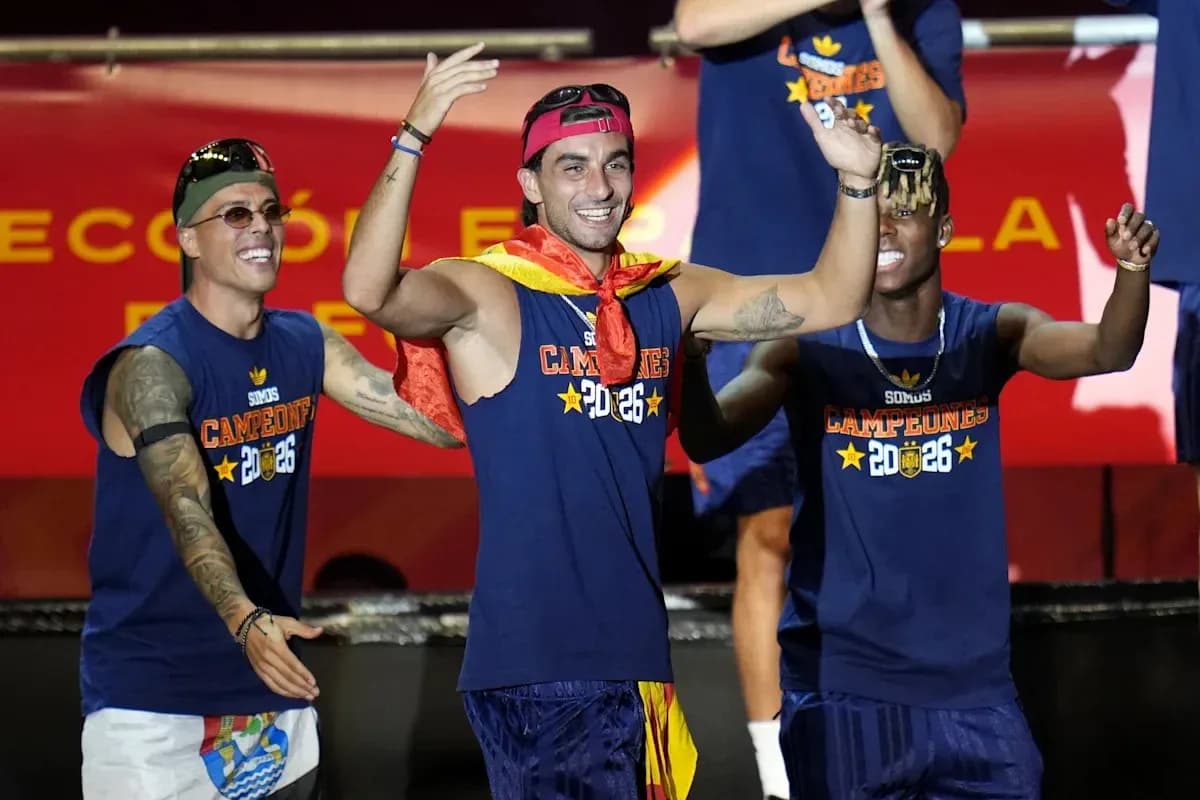 Players celebrating on stage with medals and flags Players celebrating on stage with medals and flags