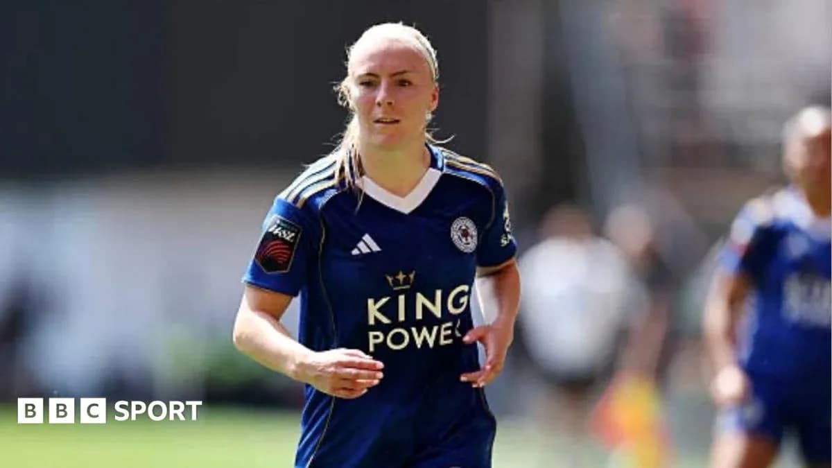 Female player in blue jersey running on field Female player in blue jersey running on field