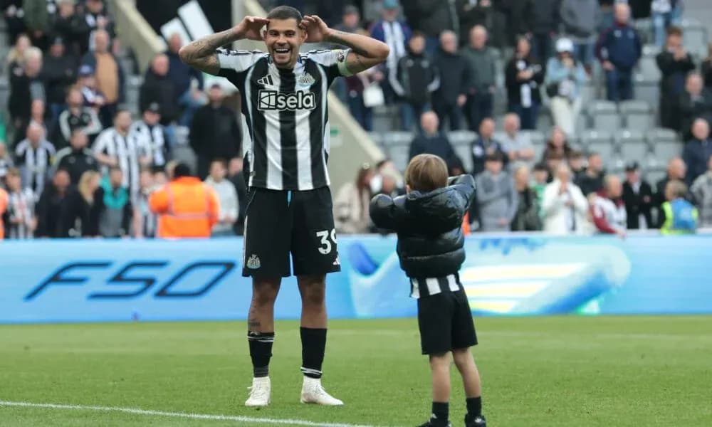 Newcastle player celebrating with young fan after match Newcastle player celebrating with young fan after match