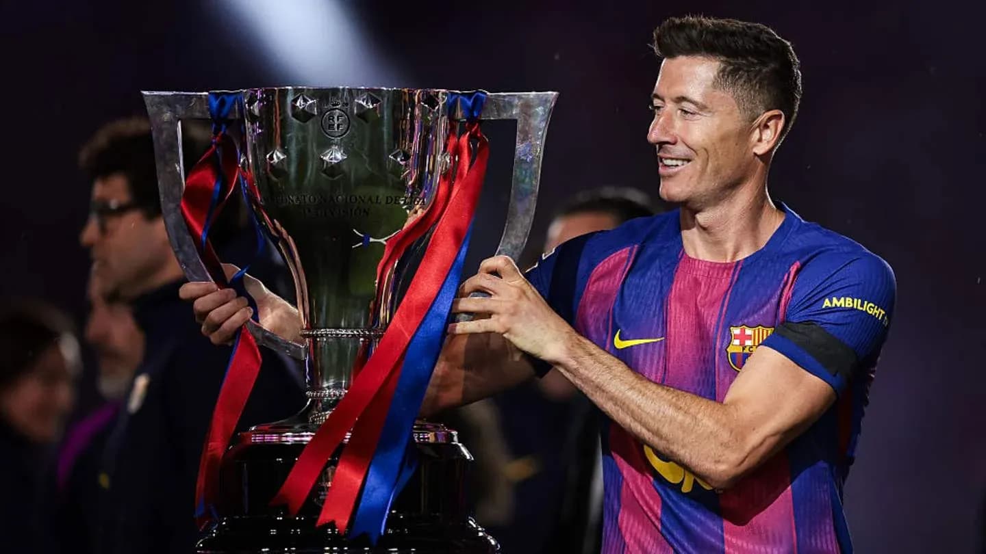 Player holding trophy during celebration ceremony Player holding trophy during celebration ceremony