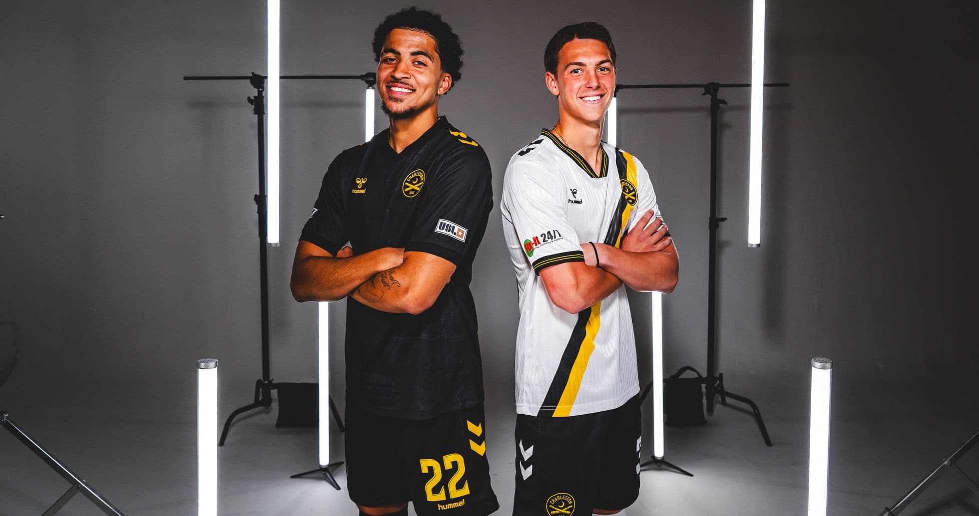 Two players in team jerseys posing together Two players in team jerseys posing together