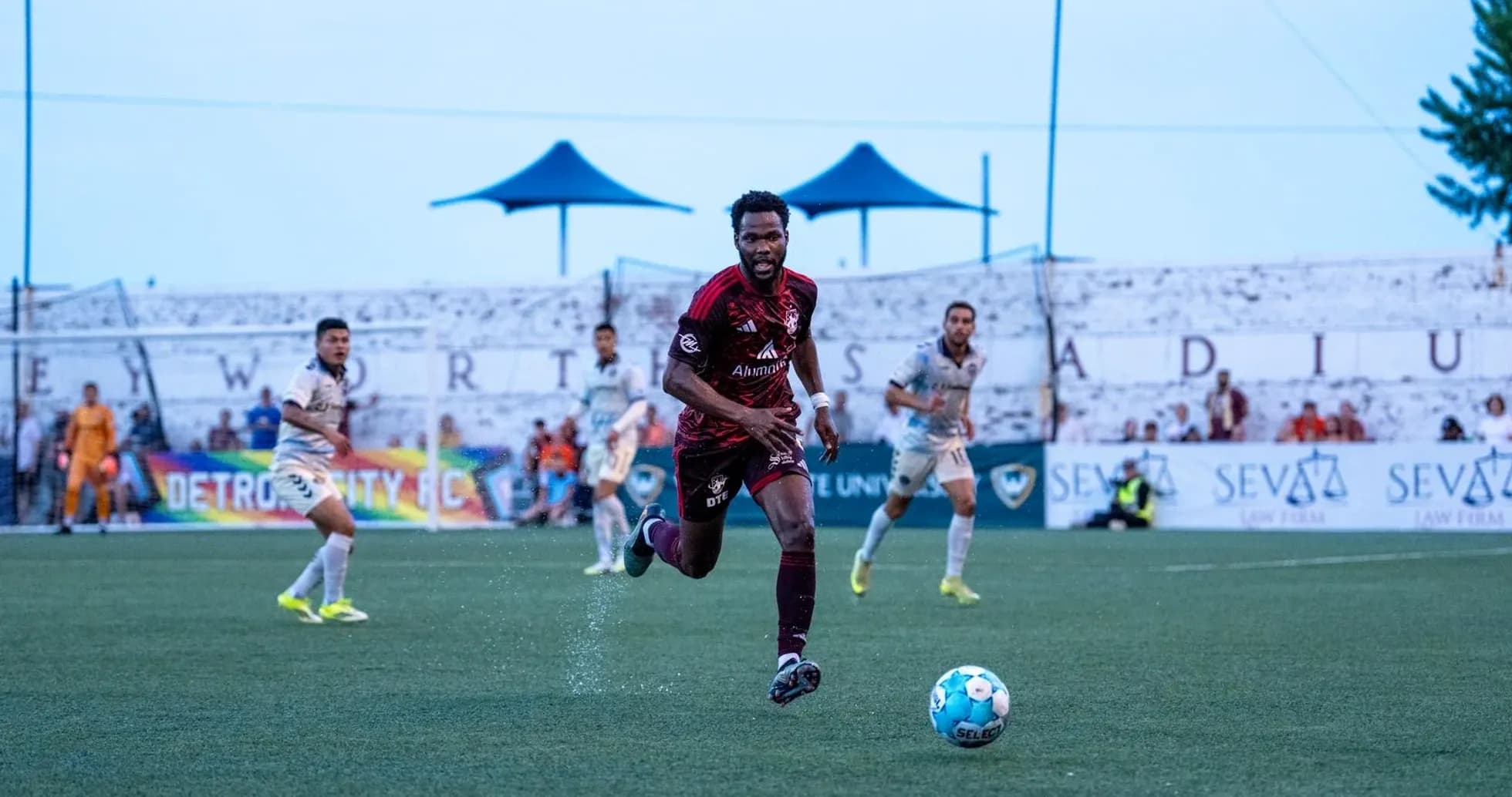 Player running with ball during Detroit City match Player running with ball during Detroit City match