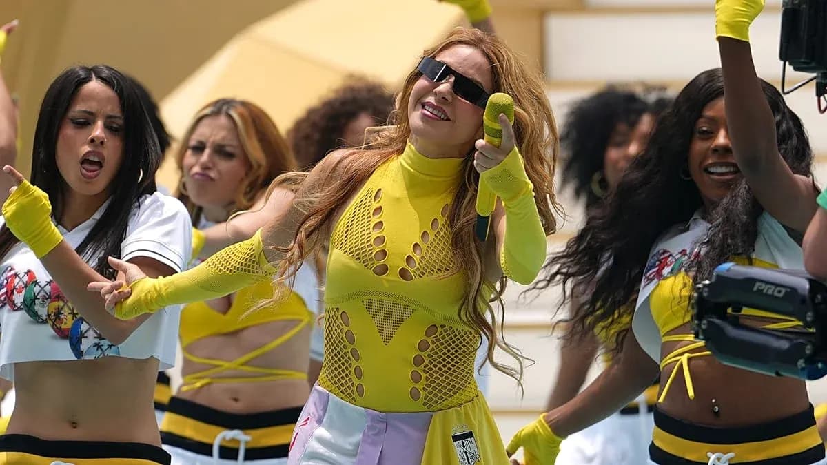 Performer singing with dancers in colorful outfits Performer singing with dancers in colorful outfits