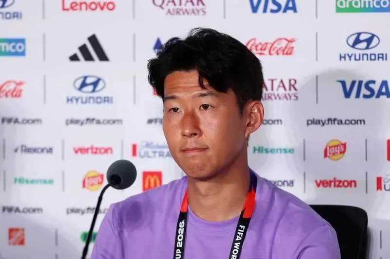 Player at press conference with sponsor logos behind Player at press conference with sponsor logos behind