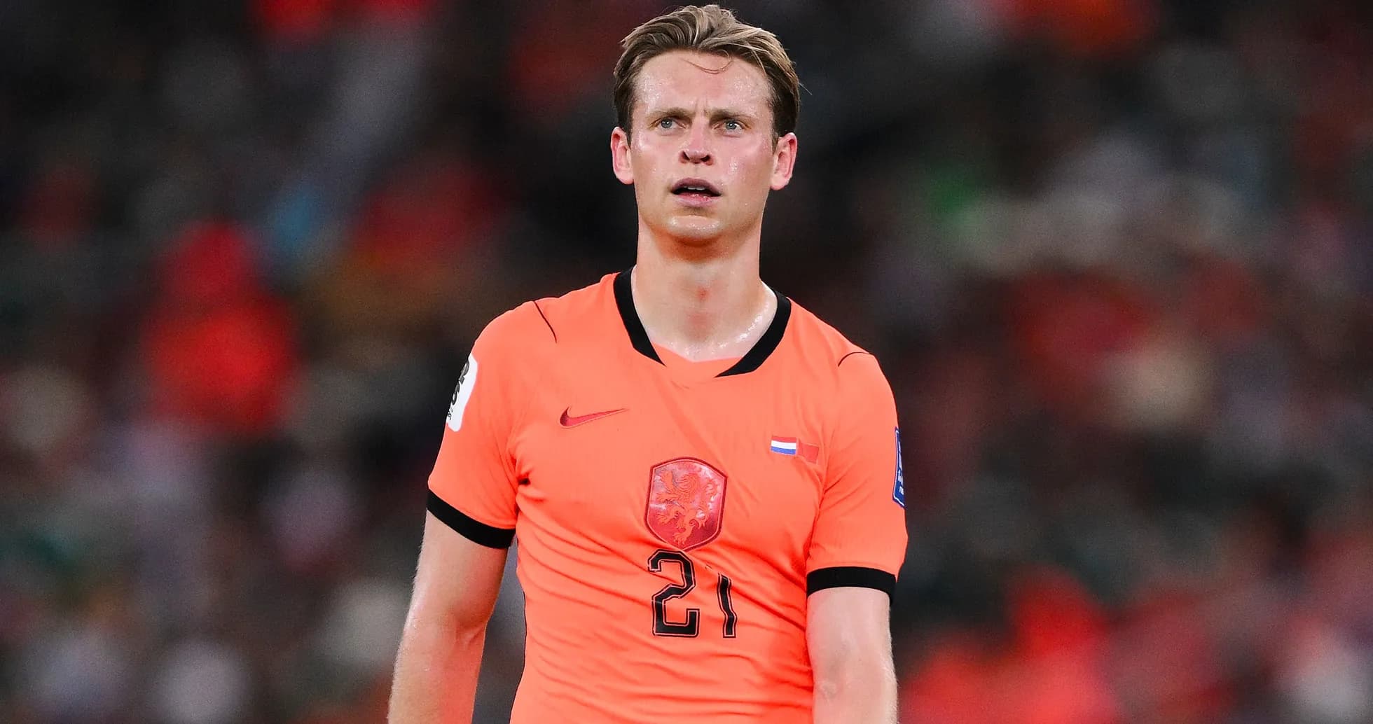 Player in orange jersey during a football match Player in orange jersey during a football match