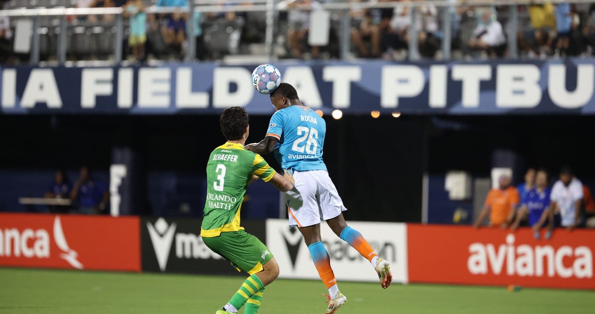 Player heading the ball during match action Player heading the ball during match action